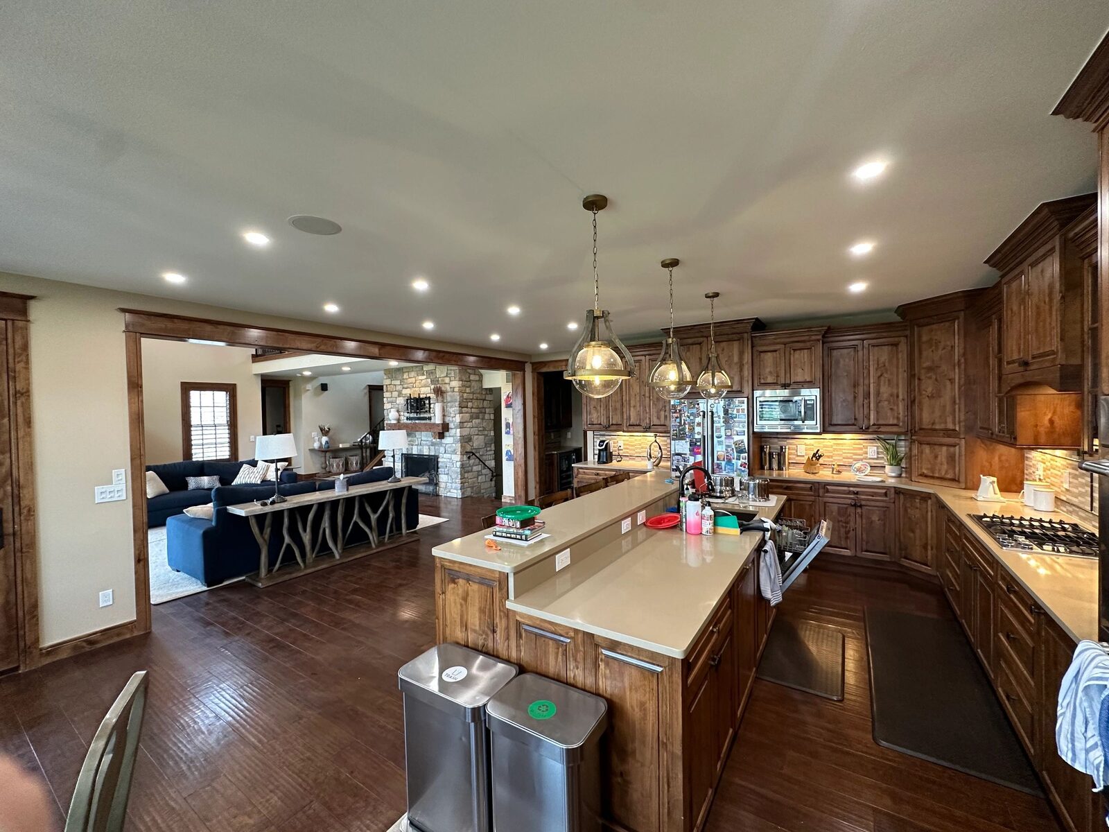 Kitchen with pendant lights over the island and recessed ceiling lighting.